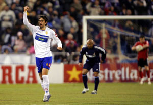 Real Zaragoza's Diego Milito (L) of Argentina celebrates a goal against Real Madrid during their Spanish King Cup semi-final soccer match in Zaragoza, Spain February 8, 2006. 