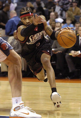 Philadelphia 76ers guard Allen Iverson uses his hand to clear his way around Charlotte Bobcats center Primoz Brezec during NBA action at Bobcats Arena in Charlotte, North Carolina February 8, 2006.