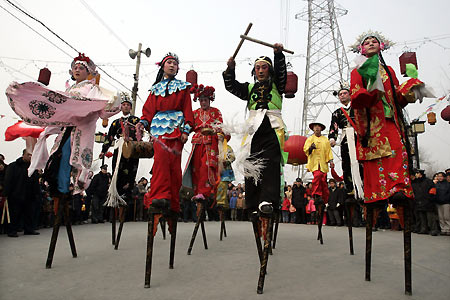 Chinese dancers on stilts perform during a Lantern Festival celebration in Beijing February 12, 2006. Lantern Festival marks the last day of the 15-day long Spring Festival, the most important festival of the year in China. [Reuters]