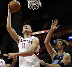 Houston Rockets center Yao Ming (11) goes up for a shot against Utah Jazz forward Mehmet Okur, of Turkey, during the second half of an NBA basketball game Saturday, Feb. 11, 2006, in Houston. Yao scored 27 points in the Rockets' 102-88 win. 