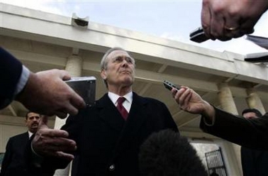 U.S. Defense Secretary Donald Rumsfeld speaks with reporters following a tour of the Carthage Museum in Carthage, Tunisia February 11, 2006.