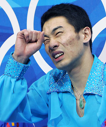 Li Chengjiang from China reacts after the figure skating men's Short Program at the Torino 2006 Winter Olympic Games in Turin, Italy, February 14, 2006. [Reuters]