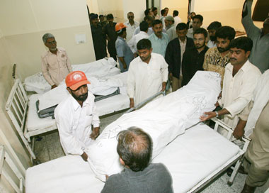Bodies of the Chinese workers are brought to a hospital after a shooting incident in the Pakistani town of Hub, near Karachi, February 15, 2006. Pakistani separatist gunmen killed three Chinese workers and their driver in a drive-by shooting in southern Pakistan on Wednesday,