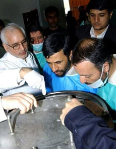 Iran's president Mahmoud Ahmadinejad (center), President of the Atomic Energy Organization of Iran Reza Aghazadeh (left) and Ahmadinejad's close advisor and cabinet secretary Masoud Zaribafan, right, visit the Natanz uranium enrichment facilities some 200 miles (322 km) south of the capital Tehran on Wednesday, Feb. 15, 2006. [AP]