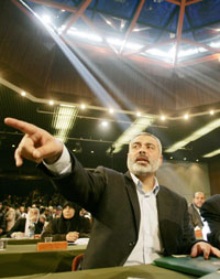 Ismail Haniyeh, Hamas leader and the Palestinian Authority's next prime minister, gestures during a parliament meeting in Gaza February 18, 2006. Hamas took over as the dominant party in the Palestinian parliament on Saturday and named its leader Ismail Haniyeh as the Palestinian Authority's next prime minister.