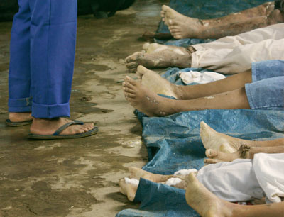 The victims of a mudslide are lined up on the ground in the remote farming village of Guinsaugon, near Saint Bernard town, in southern Leyte province, central Philippines February 18, 2006. Hopes faded on Saturday for some 1,800 people in a central Philippine village engulfed by a torrent of mud and rock when a rain-soaked mountain collapsed on homes and a crowded school.