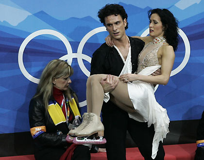 Patrice Lauzon carries Marie-France Dubreuil from Canada after their performance in the original dance figure skating event at the Torino 2006 Winter Olympic Games. [Reuters]