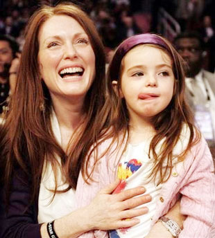 Actress Julianne Moore holds her daughter Liv, 3, before the start of the NBA All-Star basketball game in Houston, Sunday, Feb. 19, 2006. (AP 