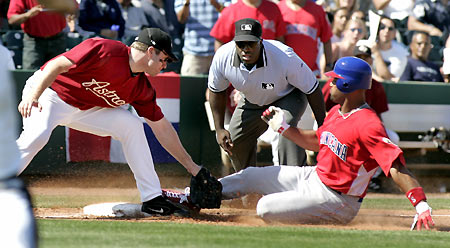 Dominican Republic National Team player Albert Pujols (R) is safe at third base, beating the tag by Houston Astros third baseman Morgan Ensberg during their exhibition game at the Houston Astros spring training camp in Kissimmee, Florida, March 5, 2006. The Dominican Republic won 12-8 over the Astros and will begin play in the World Baseball Classic against Venezuela in Kissimmee on March 7. [Reuters]