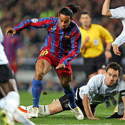 Barcelona's Ronaldinho (L) of Brazil dribbles past Chelsea's John Terry (bottom R), before scoring during their Champions League first knockout round return leg soccer match, at Nou Camp Stadium in Barcelona March 7, 2006. 