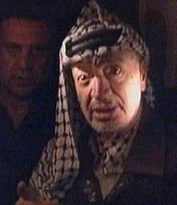 Arafat in a candle-lit interview at his ruined West Bank headquarters