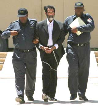 Saddam in shackles appears in court