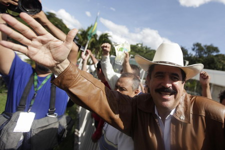 Ousted leader returns to Honduras, defies arrest