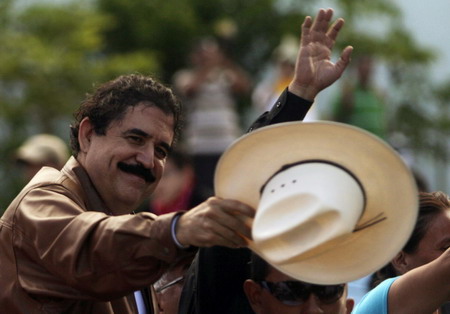Ousted leader returns to Honduras, defies arrest