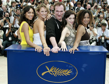 Quentin Tarantino poses with cast members at 