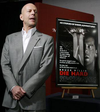 Actor Bruce Willis poses beside...