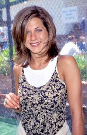 Sporting the haircut that made her a household name, Aniston smiles at the 