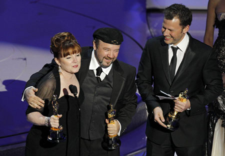 Mindy Hall, Barney Burman and Joel Harlow accept the award for best makeup