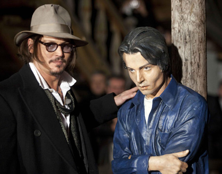 Johnny Depp with his statue