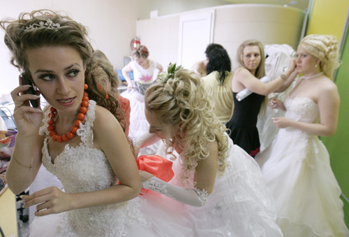 Women in bridal gowns take part in a carnival in Russia