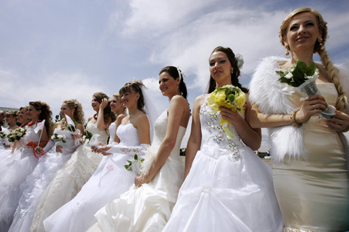 Women in bridal gowns take part in a carnival in Russia