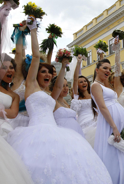 Women in bridal gowns take part in a carnival in Russia