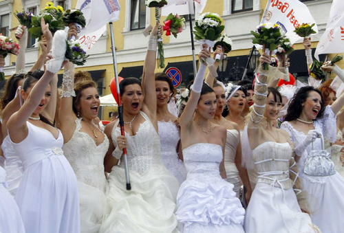 Women in bridal gowns take part in a carnival in Russia