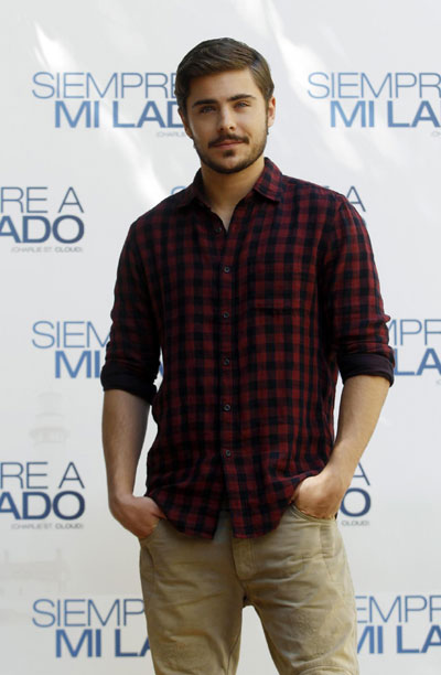 Zac Efron poses during a photocall to promote the film 'Charlie St. Cloud'