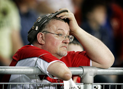 A Middlesbrough soccer fan holds his head while watching the action during the UEFA Cup final soccer match against Sevilla in Eindhoven, Netherlands May 10, 2006.