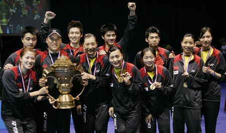 The Chinese badminton squad pose with the winners trophy for photographers after the final of the Sudirman Cup World Team Badminton Championships in Glasgow, Scotland June 17, 2007.