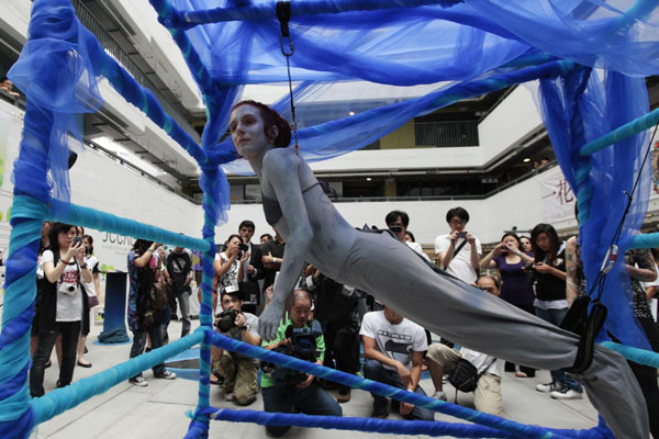 Woman hangs from hooks to protest shark killing