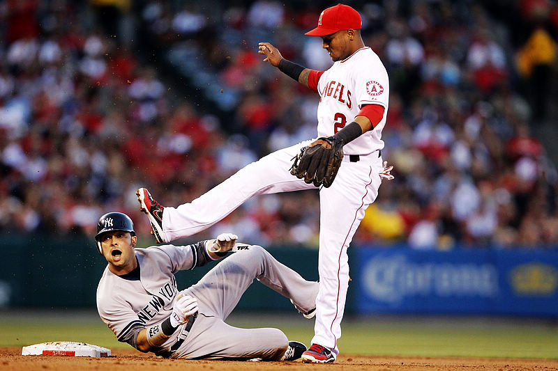New York Yankees' Nick Swisher (L) yells out looking back at first base after Los Angeles Angels shortstop Erick Aybar (2) turns a double play during the second inning of their MLB baseball game in Anaheim, California, on May 30, 2012. 2012 Sports Photos in Review: Accidents on the court