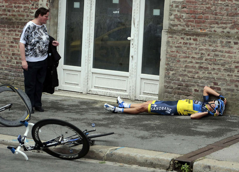 Team Saxo Bank rider Jonathan Cantwell of Australia lies on the ground after a fall during the fifth stage of the 99th Tour de France cycling race between Rouen and Saint-Quentin, on July 5, 2012. 2012 Sports Photos in Review: Accidents on the court