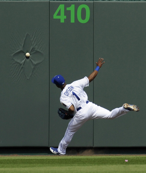 Kansas City Royals center fielder Jarrod Dyson can't reach a Cleveland Indians Jason Kipnis triple in the first inning during the Royals' home opener in their MLB American League baseball game in Kansas City, Missouri,on April 13, 2012. 2012 Sports Photos in Review: Accidents on the court