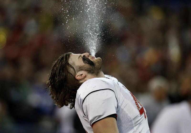 Laval Rouge et Or Arnaud Gascon-Nadon blows water from his mouth before the Vanier Cup University Championship football game against the McMaster Marauders in Toronto, on Nov 23, 2012. 2012 Sports Photos in Review: Accidents on the court