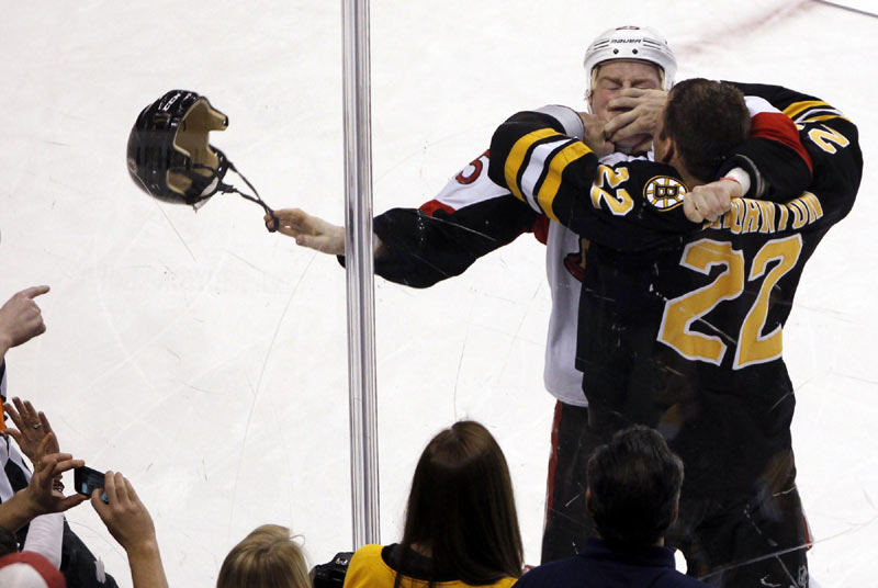 Boston Bruins' Shawn Thornton (R) fights with Ottawa Senators' Chris Neil during the first period of their NHL hockey game at TD Bank Garden in Boston, Massachusetts, on Jan 31, 2012. 2012 Sports Photos in Review: Accidents on the court