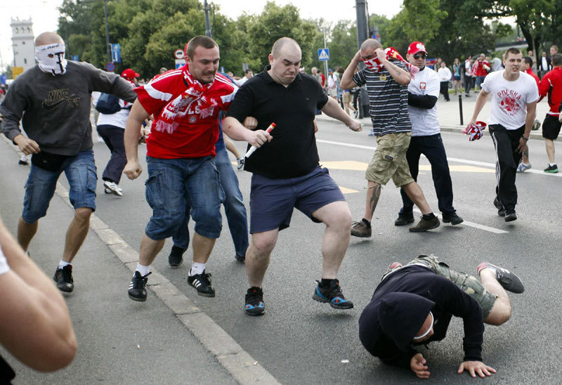Polish and Russian soccer fans clash outside the National Stadium in Warsaw, June 12, 2012. Russia on Tuesday will play Poland in their Euro 2012 Group A soccer tournament in Warsaw. 2012 Sports Photos in Review: Accidents on the court