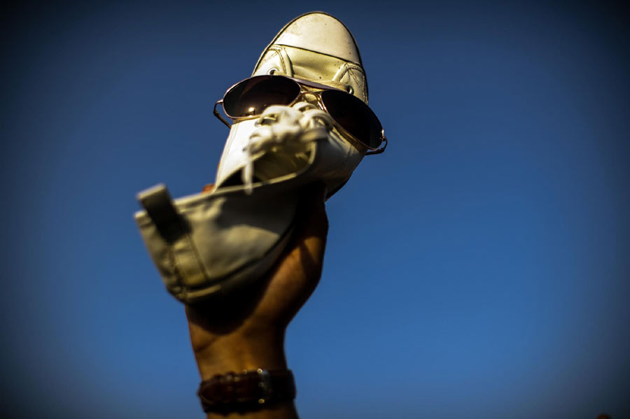 An Egyptian anti-Mubarak protester holds up his shoe at Cairo's Tahrir square on June 5, 2012. Thousands of Egyptians flocked to Cairo's iconic Tahrir square and other places on June 5, 2012 to protest the verdict handed down in ex-president Hosni Mubarak's case as well as presidential candidate Ahmed Shafiq, who they say is from the former regime. [ Xinhua world images of the year 2012