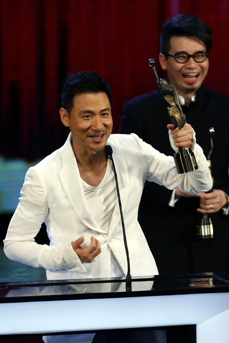Hong Kong singer Jacky Cheung celebrates after winning the Best Original Film Song award for the movie 'The Last Tycoon' at the Hong Kong Film Awards Presentation Ceremony, April 13, 2013. 'Cold War' sweeps Hong Kong Film Awards