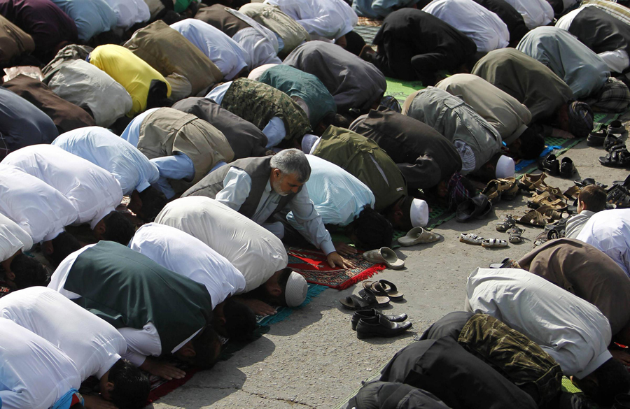 Afghans take part in morning prayers to celebrate the first day of Eid-al-Fitr outside Shah-e Doh Shamshira mosque in Kabul August 8, 2013. The Eid al-Fitr festival marks the end of the Muslim holy fasting month of Ramadan. Muslims celebrate the end of Ramadan