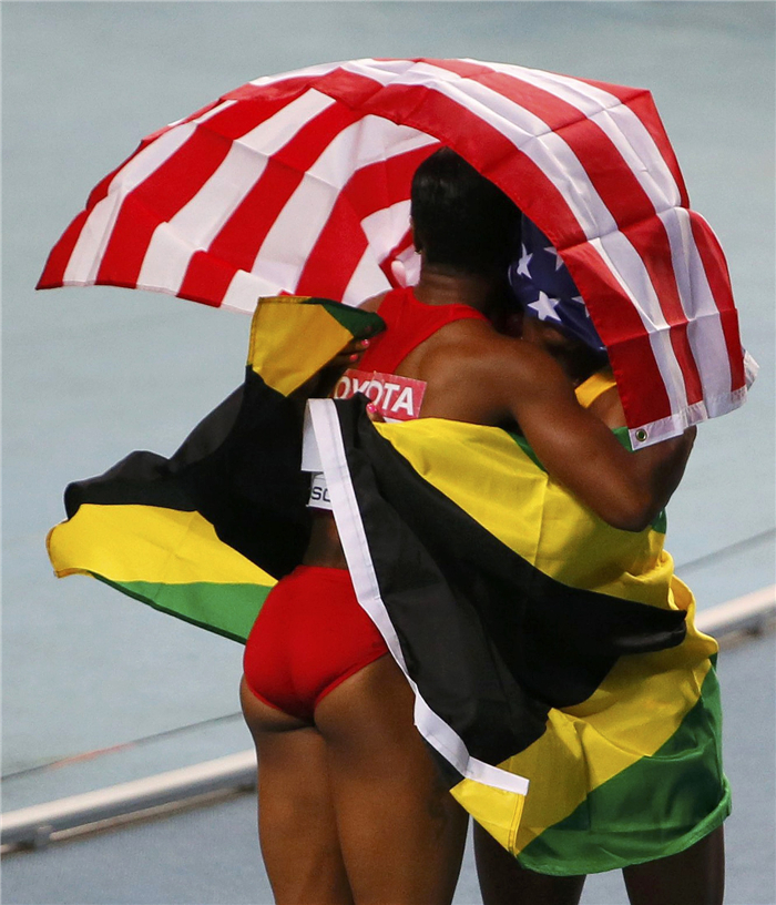 First placed Shelly-Ann Fraser-Pryce (R) of Jamaica celebrates with third placed Carmelita Jeter of the US after winning the women's 100 metres final during the IAAF Faces of triumph and defeat at athletics worlds