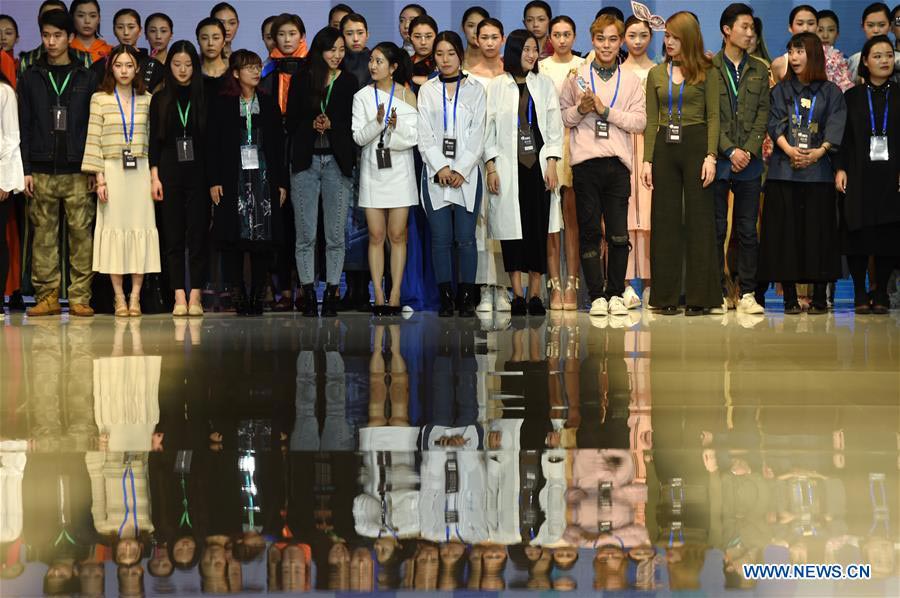 Models present fashion designs of graduates in Beijing