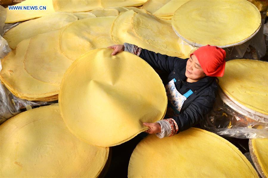Villagers make traditional food for coming Spring Festival in E China