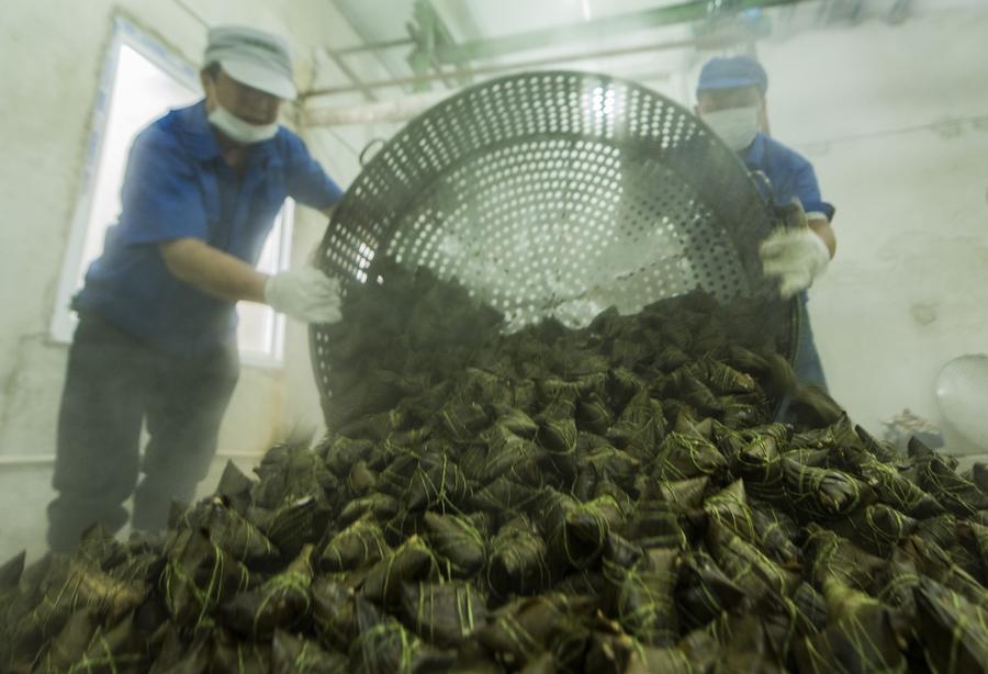 Workers in Central China make zongzi before Dragon Boat Festival
