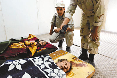利比亚知情法医透露已完成对卡扎菲遗体的检验