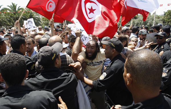 Protests rock Tunis as slain opposition leader buried