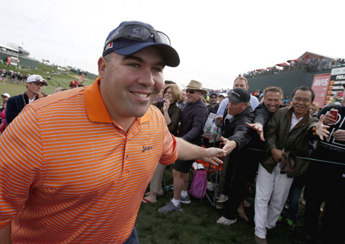 Kevin Stadler smiles as he gets handshakes from members of the gallery