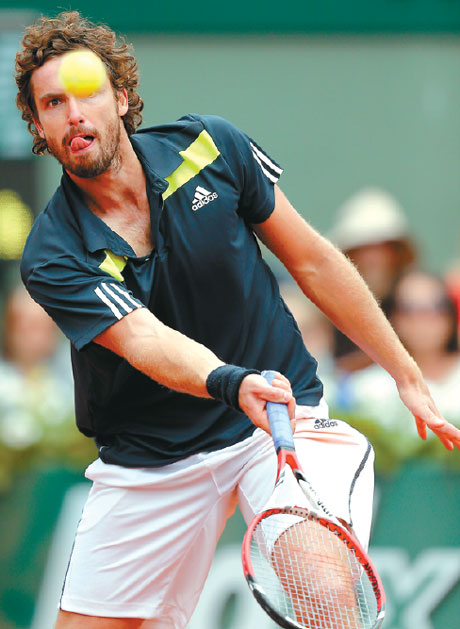 Ernests gulbis hits a return to roger federer during their 