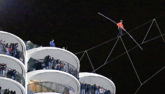 Blindfolded daredevil walks rope between towers