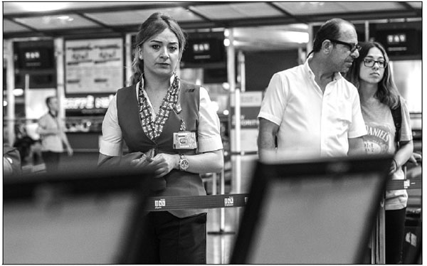 An Airport Employee Looks At The Pictures Of Killed